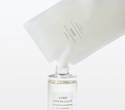 Image showing a Muji Mild Oil Cleansing refill pouch being poured into a Muji Oil Cleansing bottle.