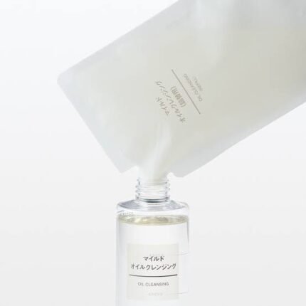 Image showing a Muji Mild Oil Cleansing refill pouch being poured into a Muji Oil Cleansing bottle.