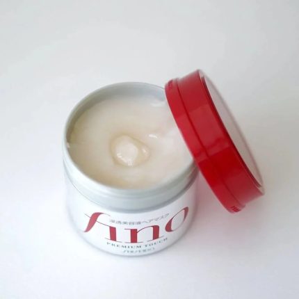 a jar of cream sitting on top of a white table